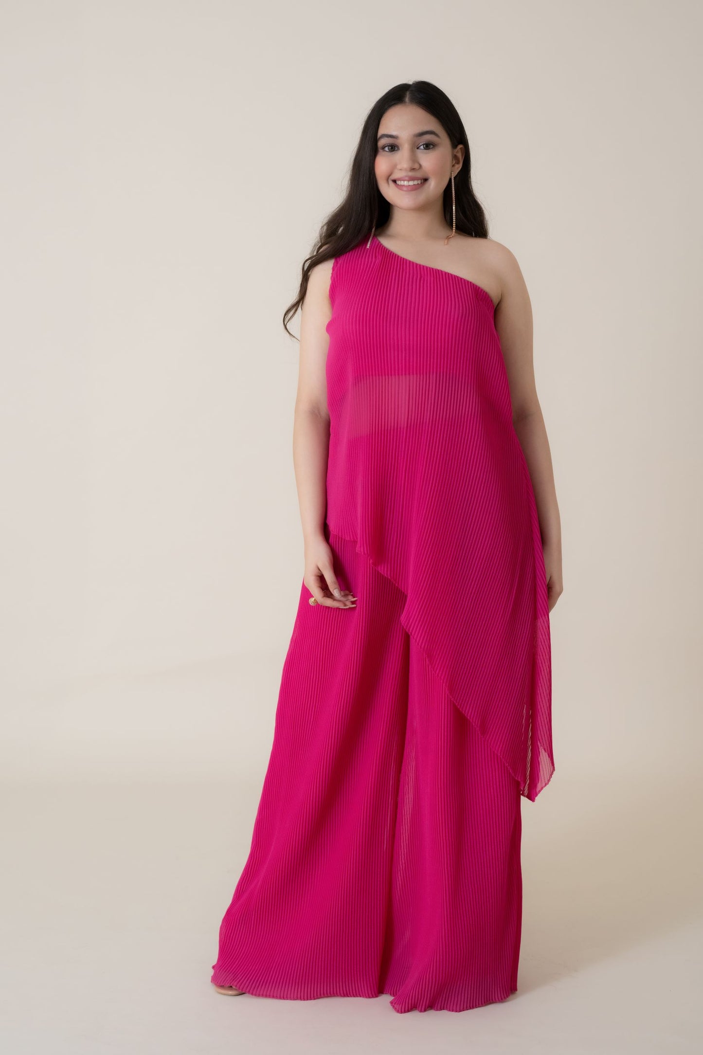 The feminine elegance and drama of this dress is beautifully highlighted when you walk in the room wearing this foxy outfit. This Tunic Set is made up of luxury pleated gerogette having an off shoulder beautifully sliced top.
