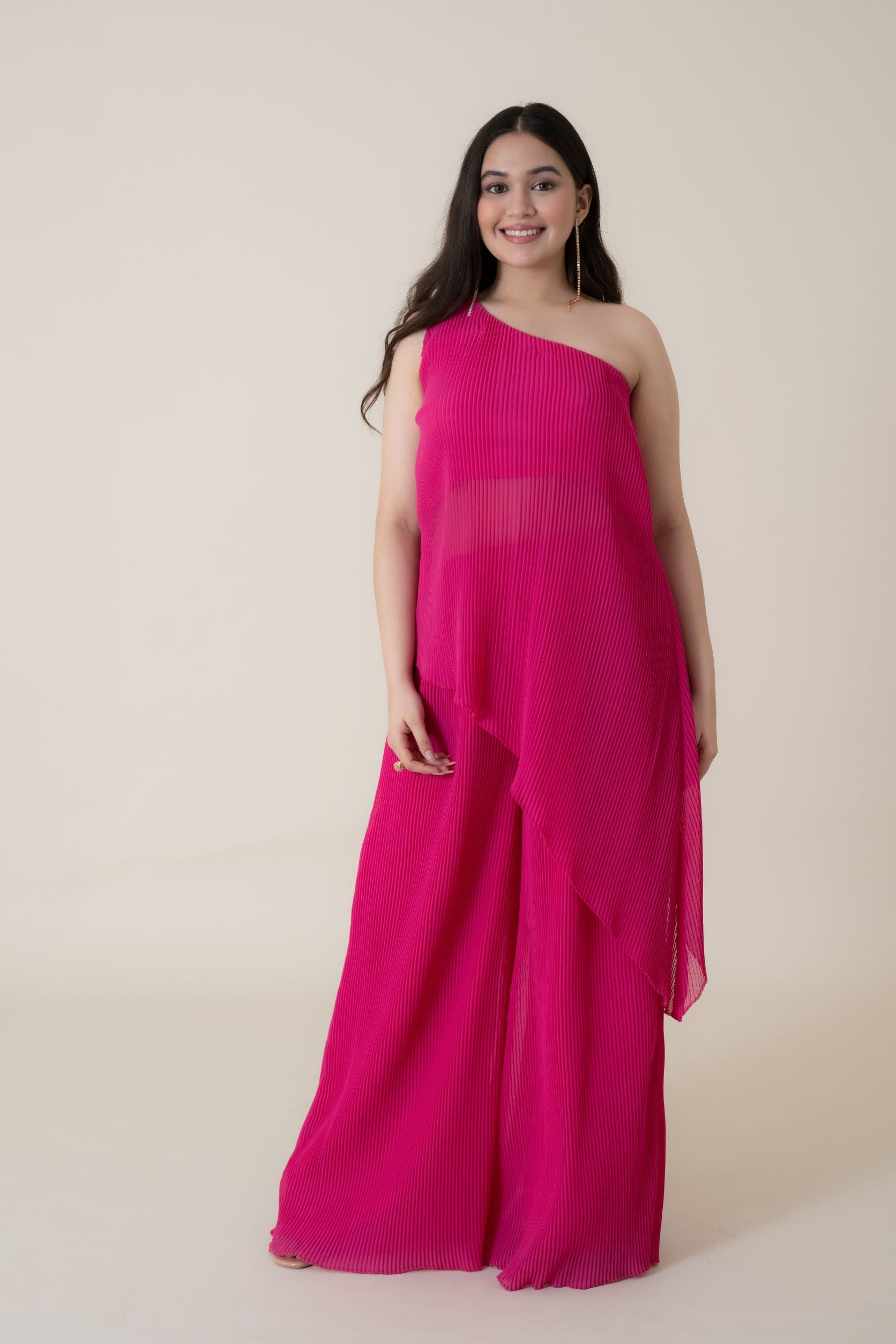 The feminine elegance and drama of this dress is beautifully highlighted when you walk in the room wearing this foxy outfit. This Tunic Set is made up of  luxury pleated gerogette having an off shoulder beautifully sliced top.
