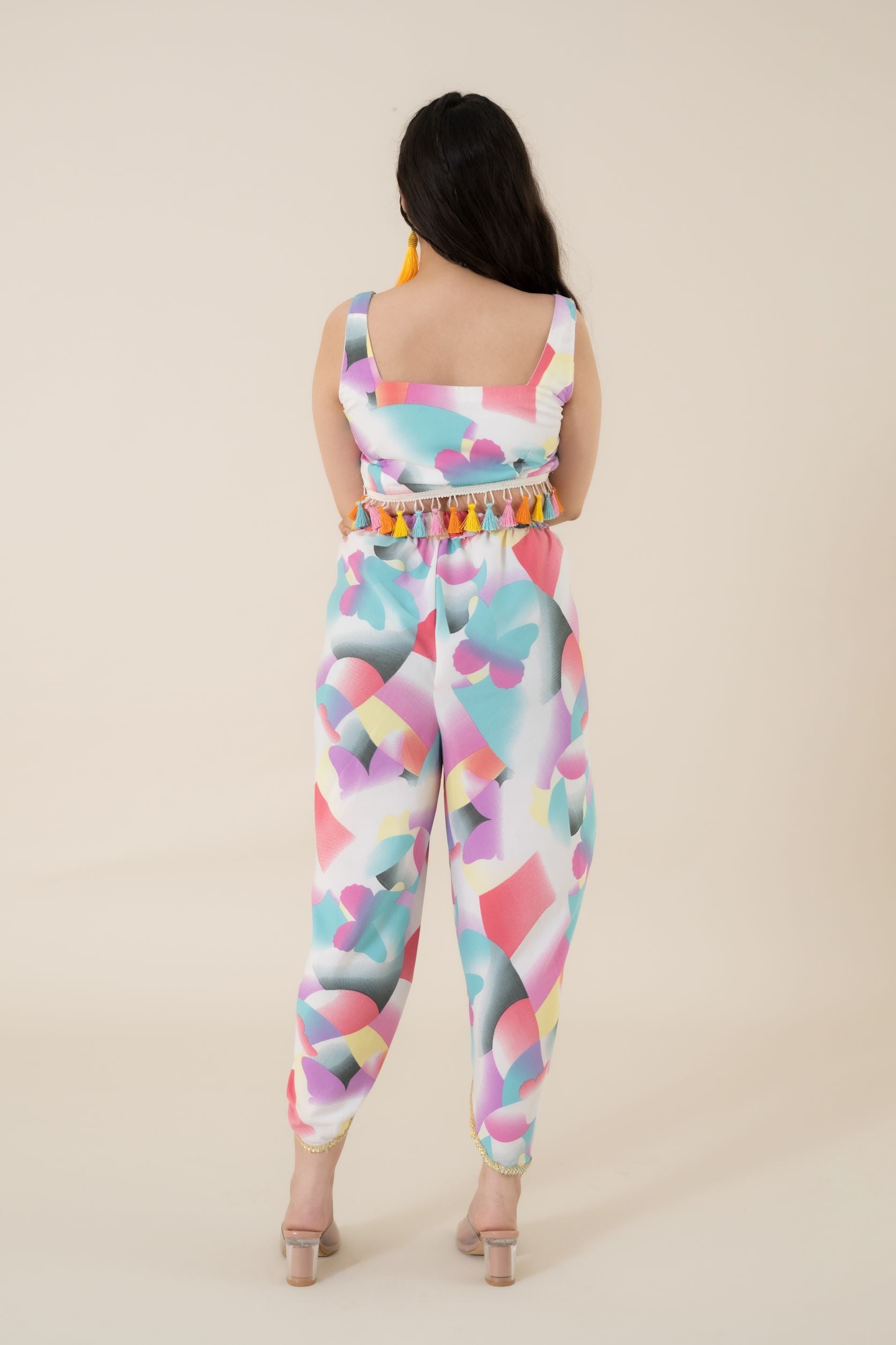 Digital printed tulip dhoti in modal satin has a multi-colored lace on the border. Its a perfect co ords form women.   Paired with a sleeveless crop top that has multi-colored tassels attached to the waistline Coord Set just feed into the demand for daily daywear and a breezy evening wear.   This is one of the few co ord sets women generally love to wear to look different and feel confident & comfortable.