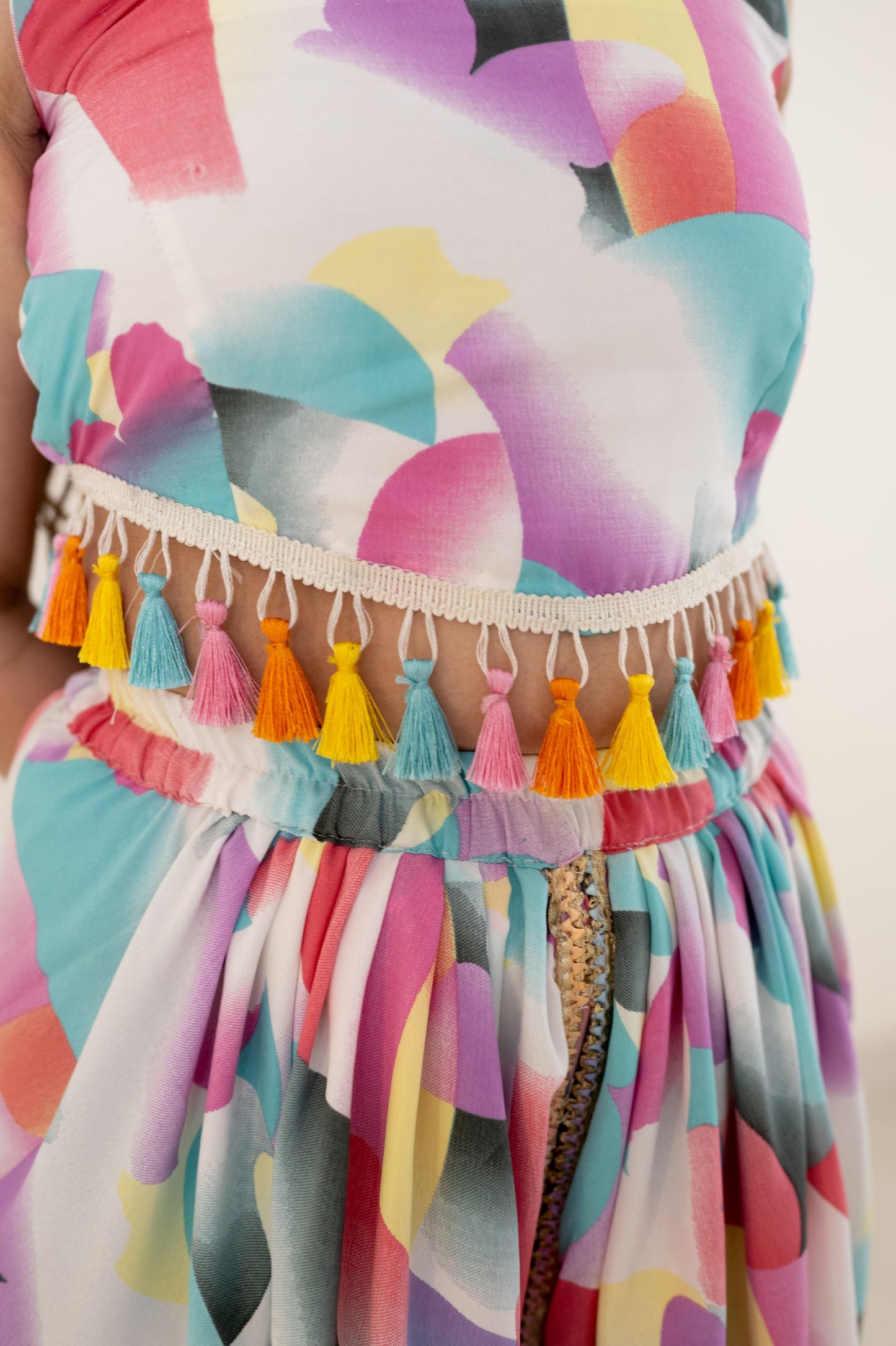 Digital printed tulip dhoti in modal satin has a multi-colored lace on the border. Its a perfect co ords form women. Paired with a sleeveless crop top that has multi-colored tassels attached to the waistline Coord Set just feed into the demand for daily daywear and a breezy evening wear. This is one of the few co ord sets women generally love to wear to look different and feel confident & comfortable.