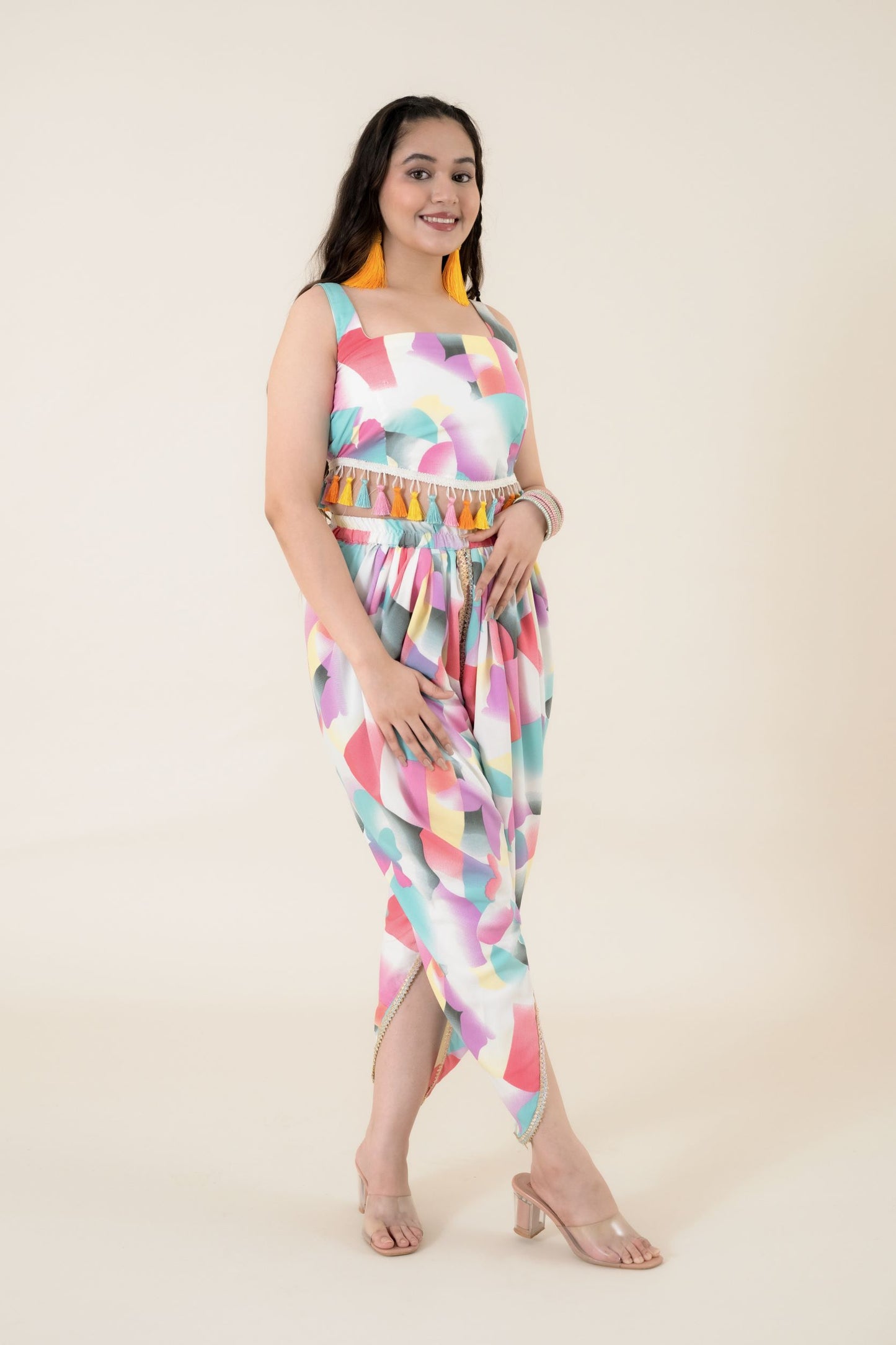 Digital printed tulip dhoti in modal satin has a multi-colored lace on the border. Its a perfect co ords form women. Paired with a sleeveless crop top that has multi-colored tassels attached to the waistline Coord Set just feed into the demand for daily daywear and a breezy evening wear. This is one of the few co ord sets women generally love to wear to look different and feel confident & comfortable.