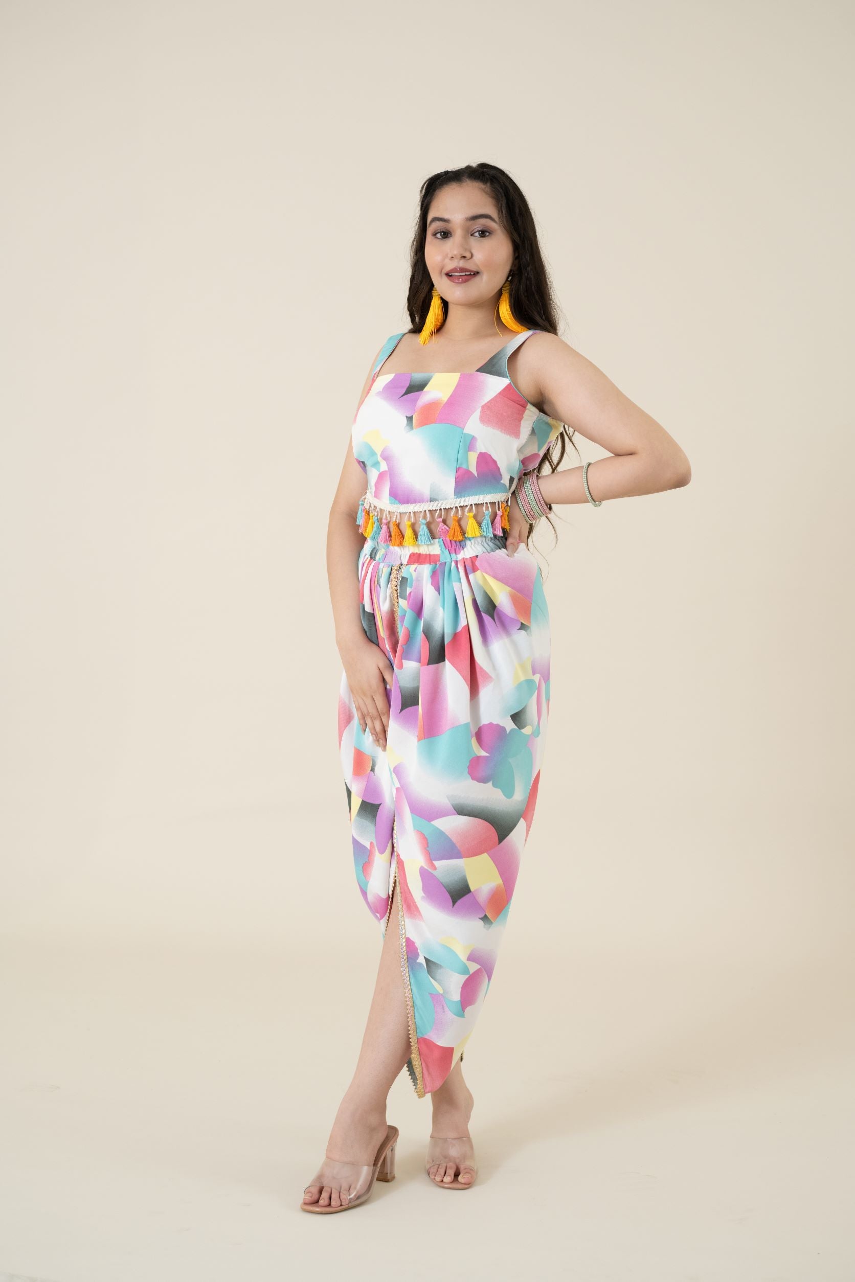 Digital printed tulip dhoti in modal satin has a multi-colored lace on the border. Its a perfect co ords form women.   Paired with a sleeveless crop top that has multi-colored tassels attached to the waistline Coord Set just feed into the demand for daily daywear and a breezy evening wear.   This is one of the few co ord sets women generally love to wear to look different and feel confident & comfortable. 